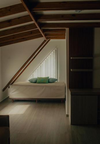 a bed with two pillows in a room at Zafi Hotel in San Andrés