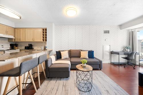 a living room with a couch and a kitchen at Downtown Toronto Studio Retreat in Toronto