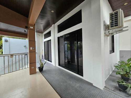 an empty hallway of a house with plants at Eagles Nest Beach Resort Room 5 in Samal