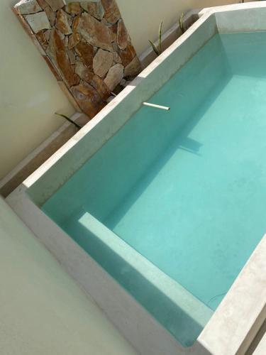 a window in a bath tub with a rock at Casa Magnolia, in Mérida Yucatán in Kanasín