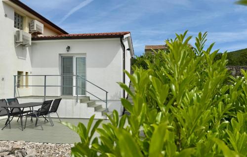 a patio with a table and chairs next to a house at Cozy Apartment In Labin With Wifi in Labin