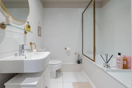 a white bathroom with a sink and a toilet at Luxury Liverpool City Centre Apartment with Balcony, Sleeps 8, Near Liverpool ONE and Royal Albert Docks in Liverpool