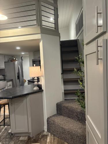 a staircase in a tiny house with a desk at The Refuge at Vanderosa in Conroe