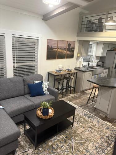a living room with a couch and a table at The Refuge at Vanderosa in Conroe