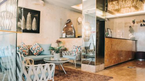 a room with couches and a table and chairs at Goldberry Suites & Hotel Mactan in Mactan