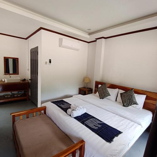 a bedroom with two beds and a tv at Nam ou view villa in Nongkhiaw
