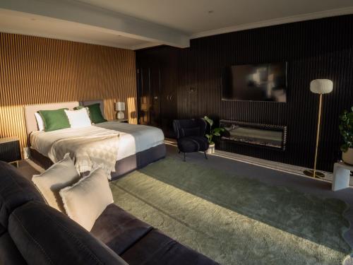 a hotel room with a bed and a couch at Sheer Pleasure Accommodation in Smithton