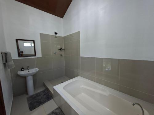 a bathroom with a bath tub and a sink at Taw K'a Cabañas 