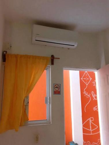 a room with a window and a curtain at Casa mexicana in Barra de Navidad