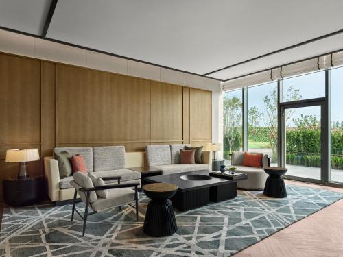 a living room with a couch and a table at Sheraton Kunshan Dianshan Lake in Kunshan