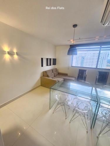 a living room with a glass table and a couch at Flat Nobile Suítes Monumental By Rei dos Flats, in Brasilia