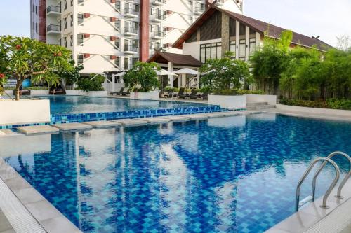 a large swimming pool in front of a building at Urban Chic Home Urban Chic Home with balcony in Pajo