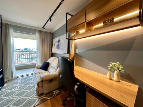 a living room with a couch and a chair in a room at Luxury Flat NEW 15 MIN AIRPORT with PARKING SPACE in Guarulhos