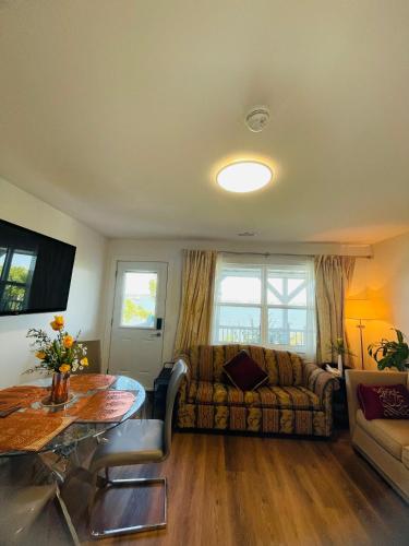 a living room with a couch and a table at Entire Cozy Apartment with Share Jacuzzi to Enjoy Amazing Views in Halifax