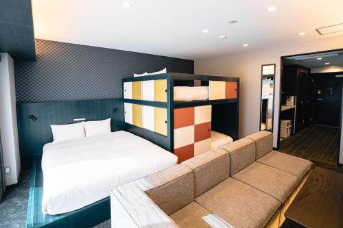 a bedroom with a bed and bunk beds in it at GOLD STAY Nagoya Sakae ゴールドステイ名古屋栄 in Nagoya