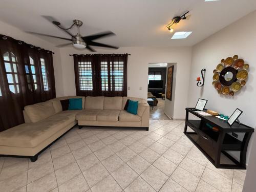 a living room with a couch and a ceiling fan at LaPlaya in Manati