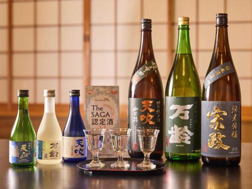 a group of wine bottles and glasses on a table at Oyado Yumechidori in Saga