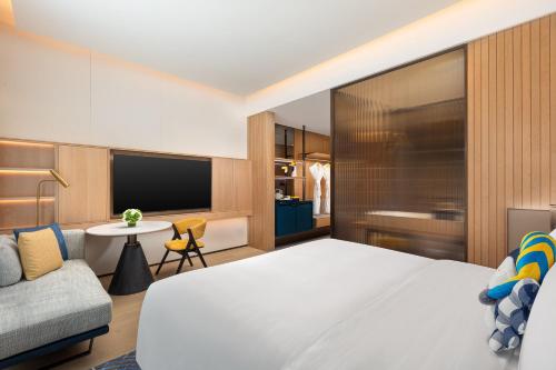a hotel room with a bed and a couch at voco Zhoushan Putuo by IHG in Zhoushan