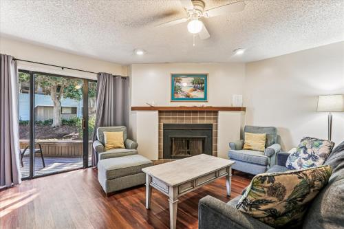 a living room with furniture and a fireplace at Beachfront Bliss Fun in St Augustine in Saint Augustine