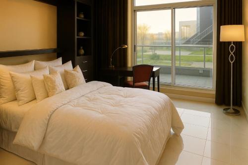 a bedroom with a white bed with a desk and a window at Luxury 2BR Designer Apartment - Prime Downtown Location! in Vancouver