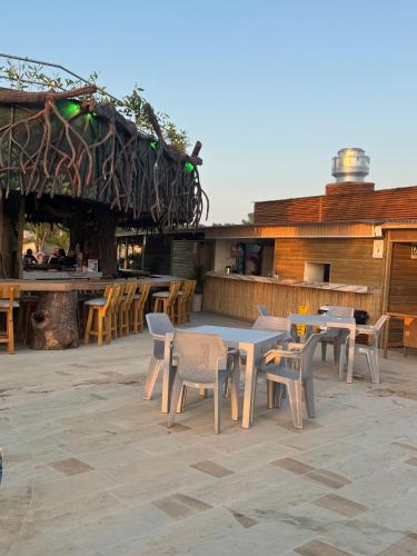 a patio with tables and chairs and a bar at Aves de Laguna Beach 