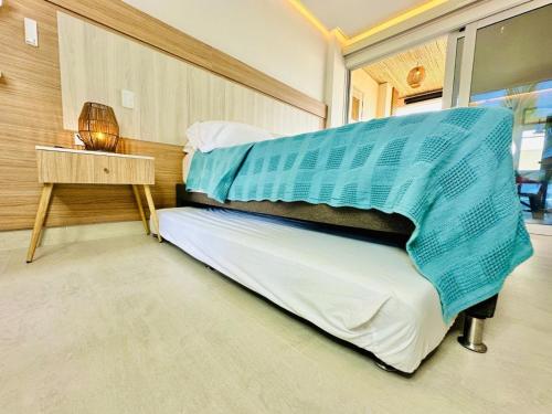 a bedroom with a bed and a nightstand and a bed sidx sidx at Aves de Laguna Beach 