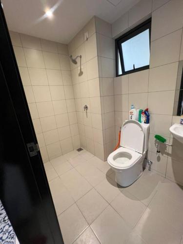 a bathroom with a toilet and a sink at Gamuda Sky Luge Maryam Homestay in Rawang