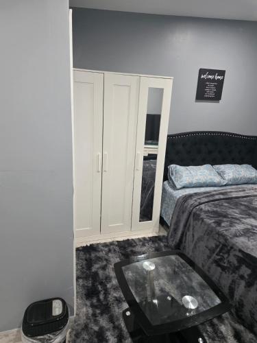a bedroom with a bed and a glass table at Newly built Studio Close to NYC and EWR in Irvington