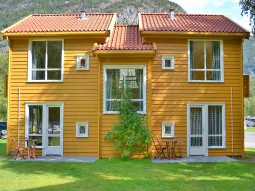 a small yellow house with a red roof at 3 person holiday park home, Lærdal in Lærdalsøyri