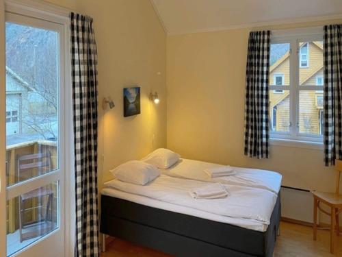 a small bed in a room with a window at 3 person holiday park home, Lærdal in Lærdalsøyri