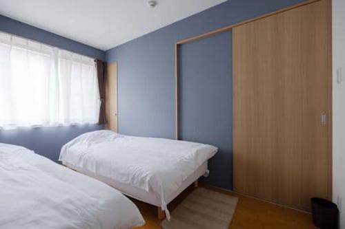 Cama o camas de una habitación en Private House NISHIOGI