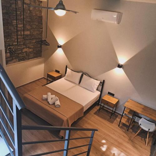 a small bedroom with a bed and a table at Mythos Maisonette in Myrina