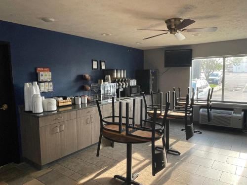 a kitchen with four chairs and a counter with a counter at New Victorian Inn & Suites Lincoln in Lincoln
