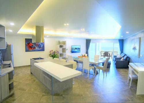 a living room with a kitchen and a dining room at Karon beach Stylish large 2BR with Sea View in Karon Beach