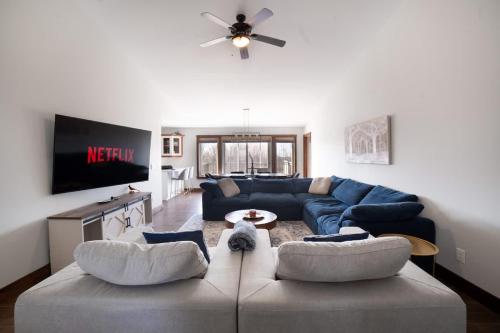 a living room with a couch and a tv at Rama Ridge with Basketball Court Hot Tub Sauna Gym in Orillia