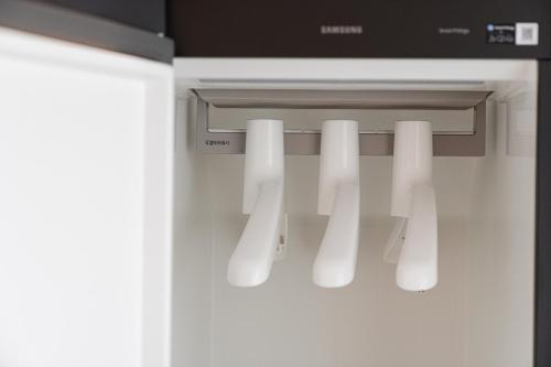 a white refrigerator with a door with white lights at Hound hotel gunsan in Gunsan
