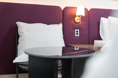 a bed with a white pillow and a table at Hound hotel gunsan in Gunsan