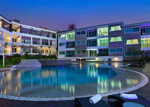 a swimming pool in front of a building at Karon beach Stylish large 2BR with Sea View in Karon Beach