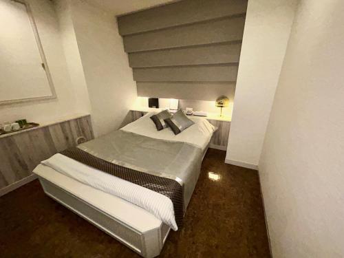 東京にあるHotel PRINCESS2 -大人専用-の小さな部屋のベッド1台が備わるベッドルーム1室