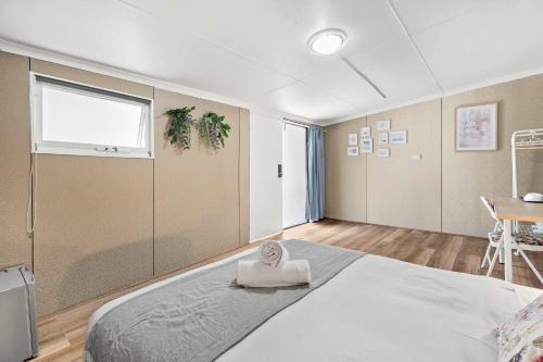 a bedroom with a bed with a towel on it at Courtyard Double Room in Peakhurst - Central Location - Shared Bathroom in Peakhurst