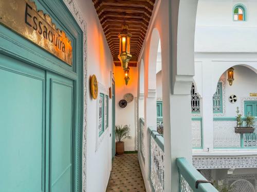 a corridor of a building with a green door at Riad medina d'or in Marrakech