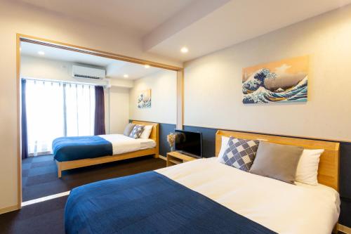Ένα ή περισσότερα κρεβάτια σε δωμάτιο στο BON Condo Namba Nipponbashi