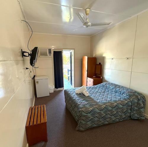 a bedroom with a bed and a bench in it at Hotel Theodore 