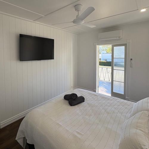 a bedroom with a bed with a hat on it at Hotel Theodore in Theodore