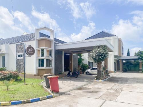 a gas station with a car parked in front of it at Urbanview Hotel Hakobox Syariah Lampung by RedDoorz in Bandar Lampung