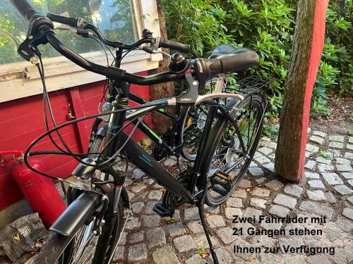 a bike parked next to a red wall at Ferienhaus direkt am Schmalensee in Schmalensee