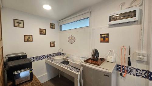 a room with a kitchen with a sink and a microwave at Black Sheep House Khaoyai by ALPHATEL PARTNER in Pong Talong