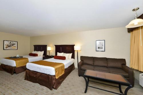 a hotel room with two beds and a couch at Best Western Frontier Motel in Lone Pine