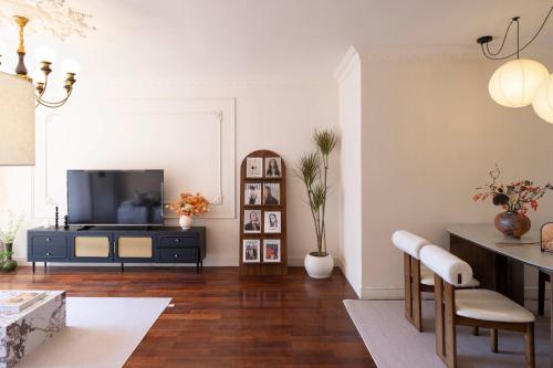 a living room with a television and a table at Book and Bed-People's Square in Shanghai