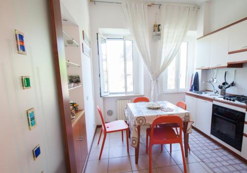 a kitchen with a table and chairs in a kitchen at La Persiana in Ancona